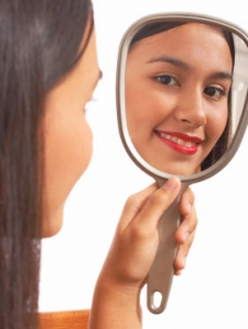 Girl smiling into mirror